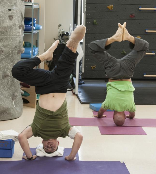 Headstanding with a US Marine Combat Veteran amputee at WRNMMC.